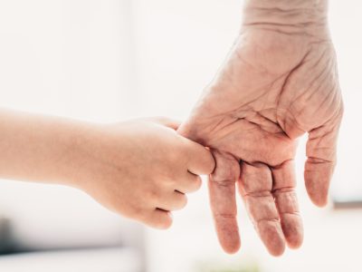 Grandparents and grandson playing at home - Grondson holding hand of his grandfather