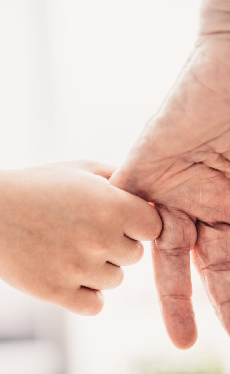 Grandparents and grandson playing at home - Grondson holding hand of his grandfather